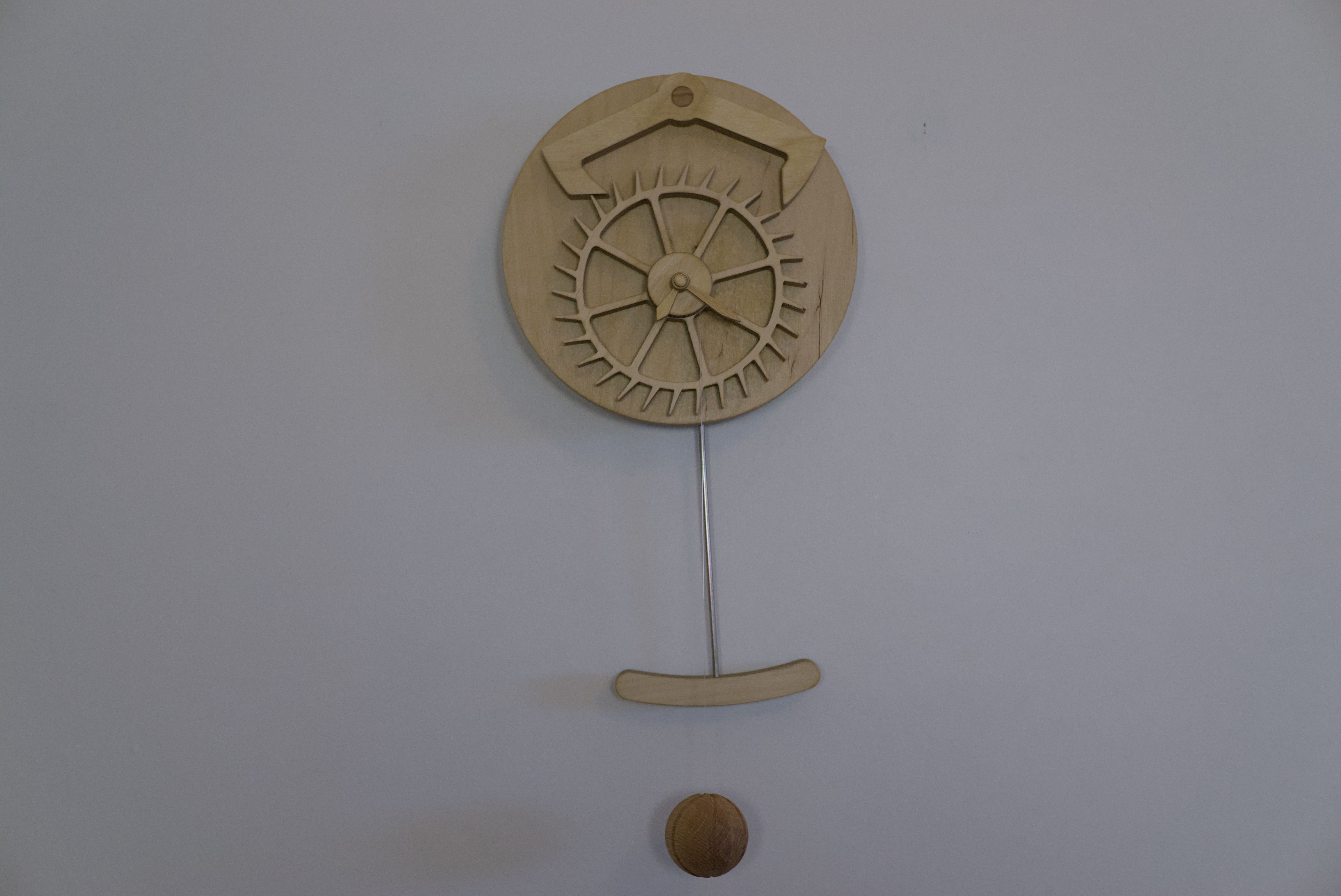 Straight on view of a clock with a decorative escapement.